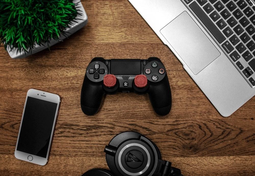 a phone and a game controller on the table