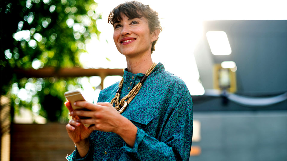 woman with smartphone in nature