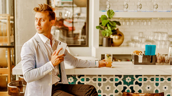 man sitting holding a iphone