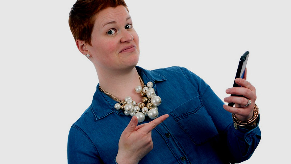 redhead woman holding smartphone