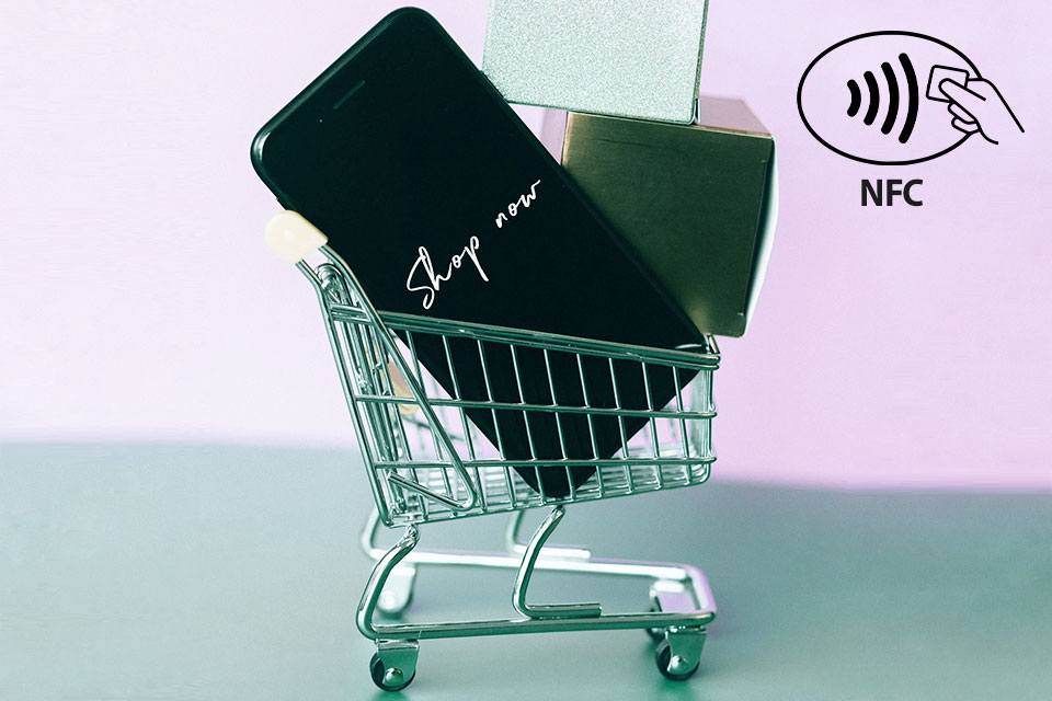 a smartphone inside a miniature shopping cart