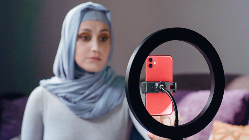 woman recording a video with her cell phone