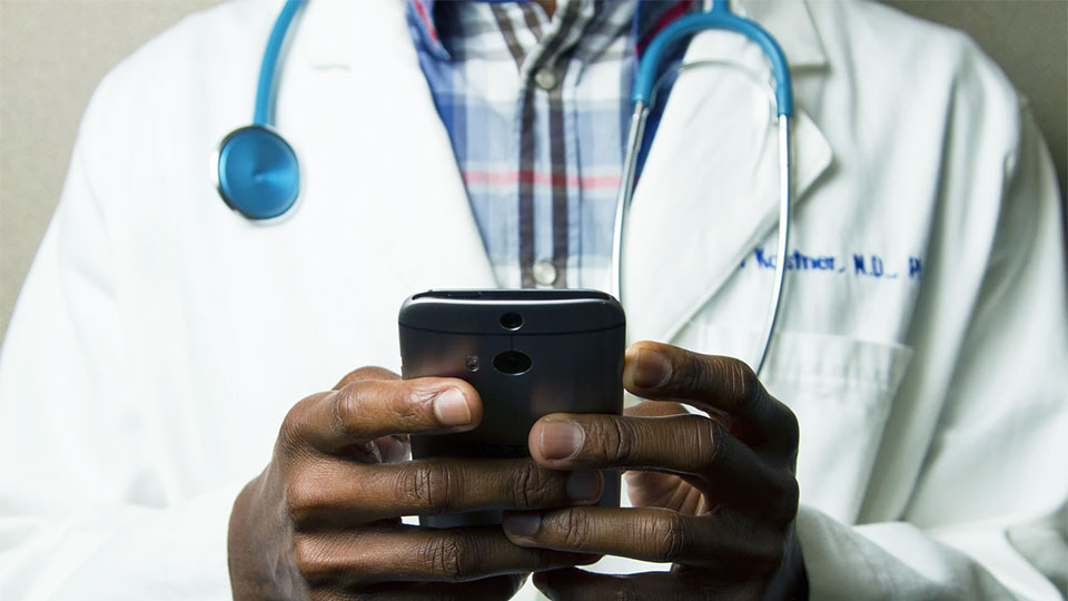 a doctor holding a smartphone