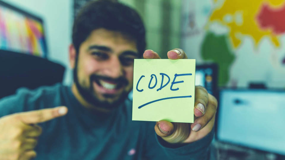 man holding a paper written code