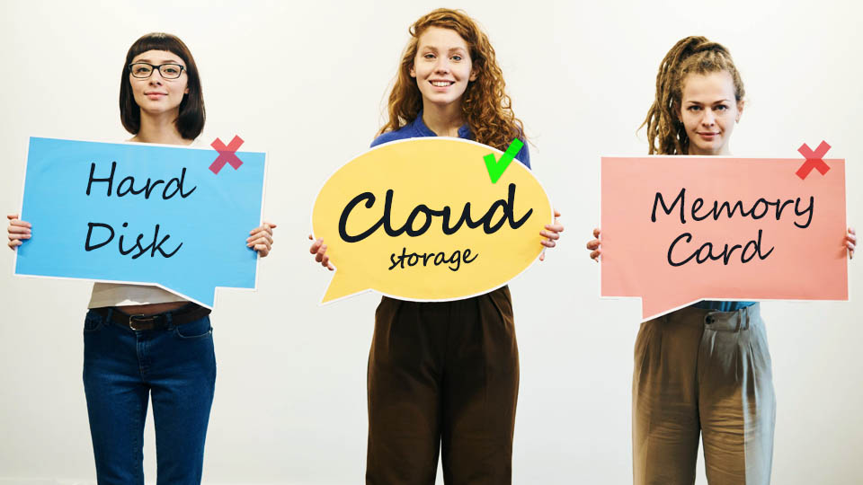 three women holding posters, one of them with cloud storage written on it