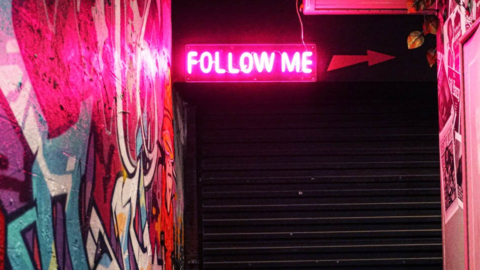 a luminous sign that says follow me