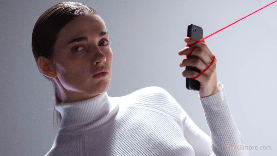 a woman holding a phone with strings attached