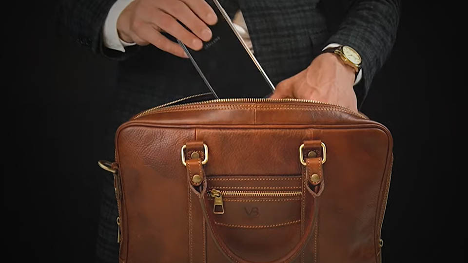 putting a smartphone in a leather bag
