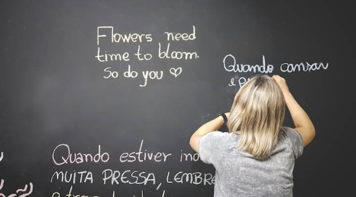 a child writing on the blackboard