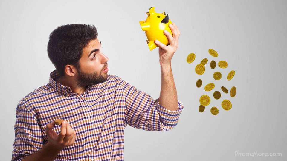 a man holding a yellow piggy bank and a coin